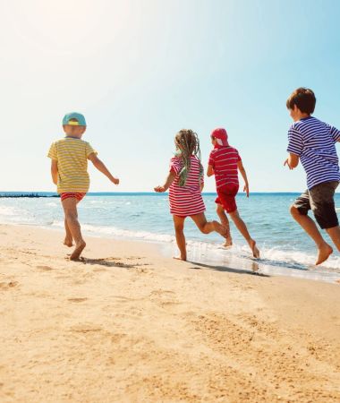 Kinder spielen am Strand von Zinnowitz sicher mit dem Kindersucharmband – hier findet ihr alle Infos für einen sicheren Familienurlaub!